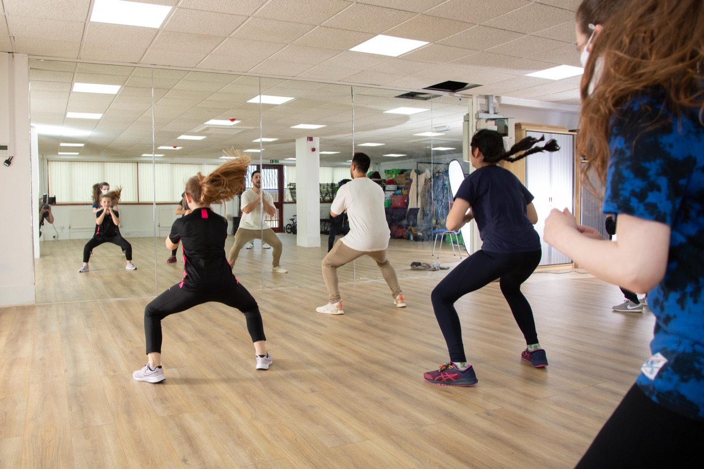 A dance class under way in a performing-arts academy's mirrored studio